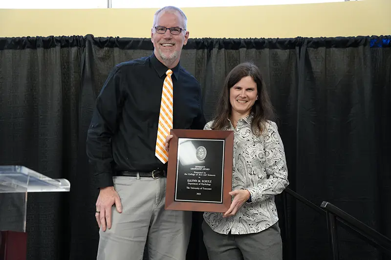 Kalynn Schulz is presented with the Diversity Leadership Award by Todd Moore at the 2023 Faculty Awards Convocation