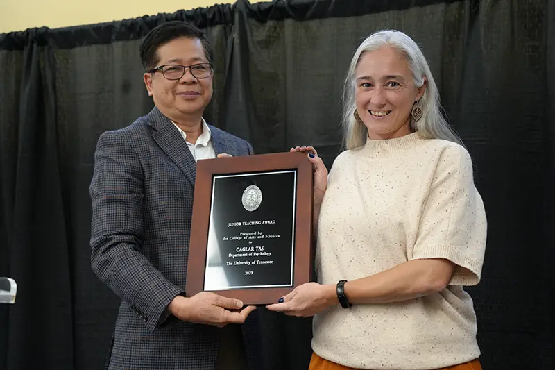 Caglar Tas is presented with an award by Liem Tran at the 2023 Faculty Awards Convocation