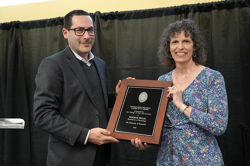 Deborah Welsh is presented with an award by Michael Blum at the 2023 Faculty Awards Convocation